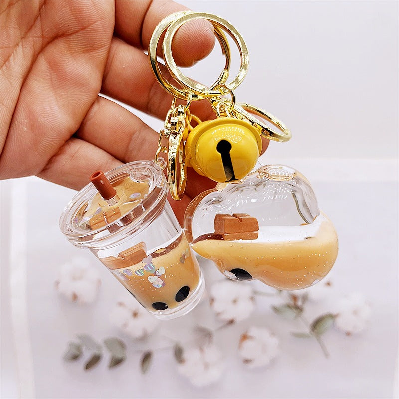 Comercio al por mayor acrílico flotando en el aceite de chocolate arenas movedizas llavero creativo